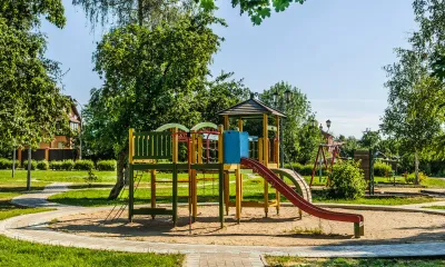 Children playing on commercial playground equipment developing motor skills