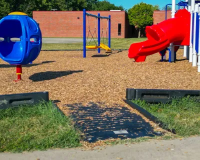 Loose-fill playground surfacing showing uneven depth and visible displacement.