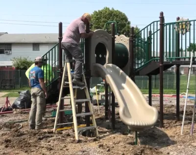 Public playground showing equipment and surfacing in an established site.