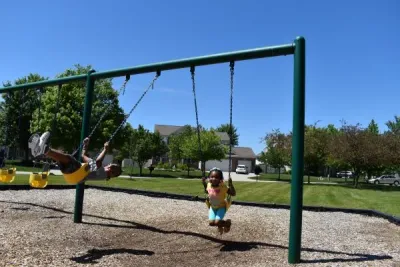 Kids Swinging On Swingset 1